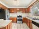 Well-lit kitchen featuring stainless steel appliances, plenty of cabinets, and tile flooring at 715 S Seminole Ave, Fort Meade, FL 33841