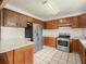 Well-lit kitchen with stainless steel appliances and lots of dark wood cabinet space at 715 S Seminole Ave, Fort Meade, FL 33841