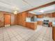 Open kitchen boasts tile floors, wood-paneled walls, stainless steel appliances, and a breakfast bar at 715 S Seminole Ave, Fort Meade, FL 33841