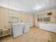 Functional laundry room with appliances, tile floor, and natural light at 715 S Seminole Ave, Fort Meade, FL 33841
