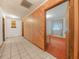 Spacious room with tile flooring, wood-paneled walls, and view to the bedroom and windows at 715 S Seminole Ave, Fort Meade, FL 33841