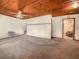 Spacious living room showcasing a decorative wood ceiling, carpeted flooring and ample natural light at 715 S Seminole Ave, Fort Meade, FL 33841