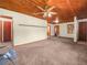 Spacious living room featuring a decorative wood ceiling, carpeted flooring and ample natural light at 715 S Seminole Ave, Fort Meade, FL 33841