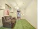 This comfy living room has green carpet with a peak into another room at 715 S Seminole Ave, Fort Meade, FL 33841