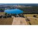 A lakefront home nestled in a lush landscape, offering tranquility and natural beauty with proximity to a tree farm at 7254 Wisteria Ln, Lake Wales, FL 33898
