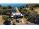 Expansive aerial view of a waterfront home with a dock and mature landscaping near a tranquil lake at 7254 Wisteria Ln, Lake Wales, FL 33898