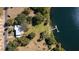 Aerial view of a house near the lake with a private dock and lush landscaping at 7254 Wisteria Ln, Lake Wales, FL 33898