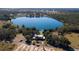 Lakefront home with lush greenery and adjacent tree farm. A serene escape for nature lovers at 7254 Wisteria Ln, Lake Wales, FL 33898