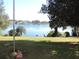 Picturesque backyard featuring a calm lake and beautiful landscape at 7254 Wisteria Ln, Lake Wales, FL 33898