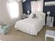 Bright bedroom featuring a plush white bed, accent pillows, and natural light through sheer curtains at 7254 Wisteria Ln, Lake Wales, FL 33898