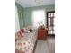 Charming bedroom with floral bedding, a window, and cozy decor at 7254 Wisteria Ln, Lake Wales, FL 33898
