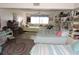 Cozy bedroom featuring multiple beds, a colorful rug, and a comfortable atmosphere at 7254 Wisteria Ln, Lake Wales, FL 33898