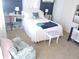 Cozy bedroom featuring carpet, a bed with white linens, a patterned chair, and lots of natural light at 7254 Wisteria Ln, Lake Wales, FL 33898