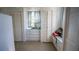 Well-lit closet space featuring built-in storage, a window seat, and classic louvered closet doors at 7254 Wisteria Ln, Lake Wales, FL 33898