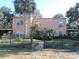 Lovely two-story home featuring well-maintained landscaping, mature trees, and fenced front yard at 7254 Wisteria Ln, Lake Wales, FL 33898