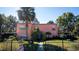 Lovely two-story home featuring well-maintained landscaping, mature trees, and fenced front yard at 7254 Wisteria Ln, Lake Wales, FL 33898