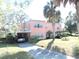 Beautiful home featuring mature palm trees, carport, and a long driveway in a landscaped setting at 7254 Wisteria Ln, Lake Wales, FL 33898