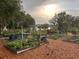 Organized garden with multiple raised beds and mulch paths, offering beautiful lakeside views at 7254 Wisteria Ln, Lake Wales, FL 33898