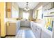 Functional vintage kitchen with white cabinets, tile floors, and classic appliances at 7254 Wisteria Ln, Lake Wales, FL 33898