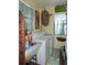 Laundry room with vintage-style decor, washer, dryer, and utility sink at 7254 Wisteria Ln, Lake Wales, FL 33898