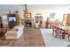 Open-concept living room features a brick fireplace, wood floors and dining area at 7254 Wisteria Ln, Lake Wales, FL 33898