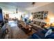 Bright living room with a tan couch and an area rug, next to the dining room at 7254 Wisteria Ln, Lake Wales, FL 33898