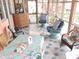 Charming screened porch with colorful seating and a dining area at 7254 Wisteria Ln, Lake Wales, FL 33898