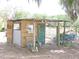 Functional outdoor shed featuring a covered area, ample storage, and lake access at 7254 Wisteria Ln, Lake Wales, FL 33898