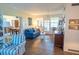 Bright sitting room with a blue sofa and access to other living spaces at 7254 Wisteria Ln, Lake Wales, FL 33898
