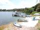 Picturesque waterfront with a dock, boats, and seating, perfect for lakeside enjoyment at 7254 Wisteria Ln, Lake Wales, FL 33898