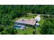 Aerial view of home showcases a large screened-in pool and mature landscaping at 7591 Limonia Dr, Indian Lake Estates, FL 33855