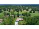 Aerial view of property with golf course in background at 7591 Limonia Dr, Indian Lake Estates, FL 33855