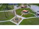 Serene outdoor space with fountain and seating area in a well-maintained community park at 7591 Limonia Dr, Indian Lake Estates, FL 33855