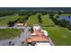 Clubhouse featuring scenic golf course views, convenient parking, and expansive green surroundings at 7591 Limonia Dr, Indian Lake Estates, FL 33855