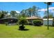 Well-maintained backyard featuring a screened-in pool area at 7591 Limonia Dr, Indian Lake Estates, FL 33855