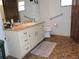 Bathroom featuring vanity with ample storage and adjacent toilet at 7591 Limonia Dr, Indian Lake Estates, FL 33855