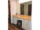Vanity area with storage, drawers and a large mirror with decorative lighting at 7591 Limonia Dr, Indian Lake Estates, FL 33855