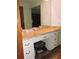 Bathroom vanity with seating area and storage cabinets at 7591 Limonia Dr, Indian Lake Estates, FL 33855