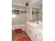 Functional bathroom with tub/shower, a large mirror, and updated vanity with storage space at 7591 Limonia Dr, Indian Lake Estates, FL 33855