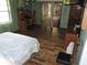 Spacious bedroom featuring hard wood floors and sliding glass door to lanai at 7591 Limonia Dr, Indian Lake Estates, FL 33855
