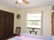 This bright bedroom features durable wood-look floors and a large window offering natural light at 7591 Limonia Dr, Indian Lake Estates, FL 33855