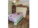 Bright bedroom featuring natural light, built-in shelves, and durable wood-look floors at 7591 Limonia Dr, Indian Lake Estates, FL 33855