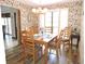 Traditional dining room with wood flooring, a chandelier, and a table set for six at 7591 Limonia Dr, Indian Lake Estates, FL 33855