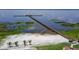 Beautiful view of private beach, dock, and lake. Relax and enjoy the sun at 7591 Limonia Dr, Indian Lake Estates, FL 33855