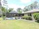 The exterior features a screened pool and patio with a well-maintained lawn and landscaping at 7591 Limonia Dr, Indian Lake Estates, FL 33855