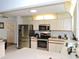 Bright kitchen with stainless steel appliances, ample cabinet space, and a center island with a breakfast bar at 7591 Limonia Dr, Indian Lake Estates, FL 33855