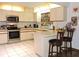 Well-lit kitchen with stainless steel appliances, ample counter space, and white cabinets at 7591 Limonia Dr, Indian Lake Estates, FL 33855