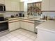 Well-appointed kitchen with stainless steel dishwasher and ample counter space, bright natural light at 7591 Limonia Dr, Indian Lake Estates, FL 33855