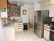 Spacious kitchen featuring stainless steel appliances, ample storage, and tiled flooring at 7591 Limonia Dr, Indian Lake Estates, FL 33855