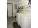 This laundry room features modern appliances, ample storage, and durable floors at 7591 Limonia Dr, Indian Lake Estates, FL 33855